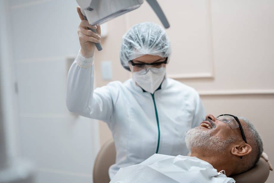 a dentist preps a patient for a root canal